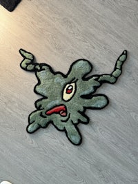 a rug with a green monster on it